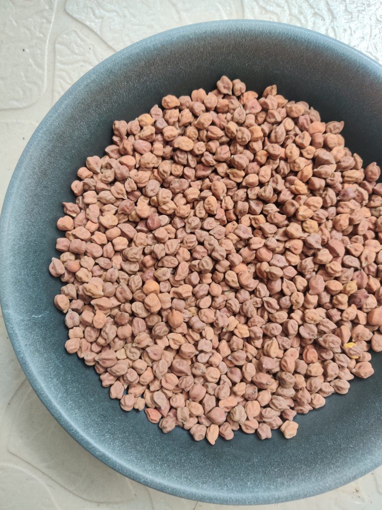 brown chana  in a black ceramic bowl