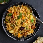 aerial shot of vegetable pulao in a black ceramic bowl