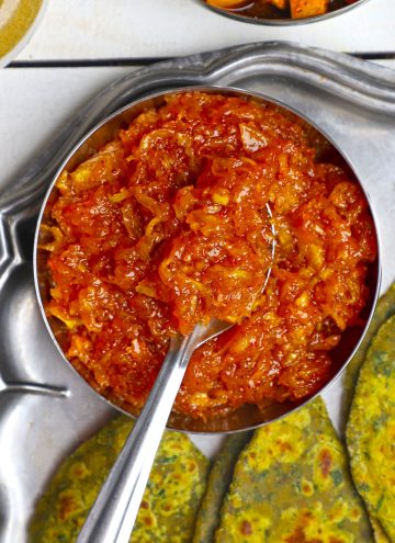 aerial shot of instant aam chunda in a stainless steel bowl with the spoon