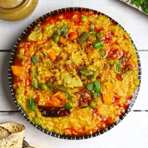 aerial shot of masala khichdi in a black ceramic bowl