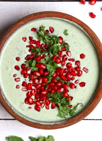 aerial shot of pomegranate mint raita in an earthen bowl