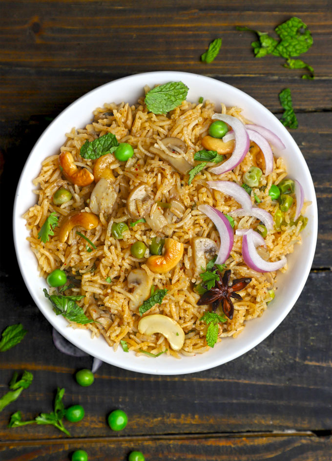 aerial shot of mushroom pulao in a white ceramic bowl