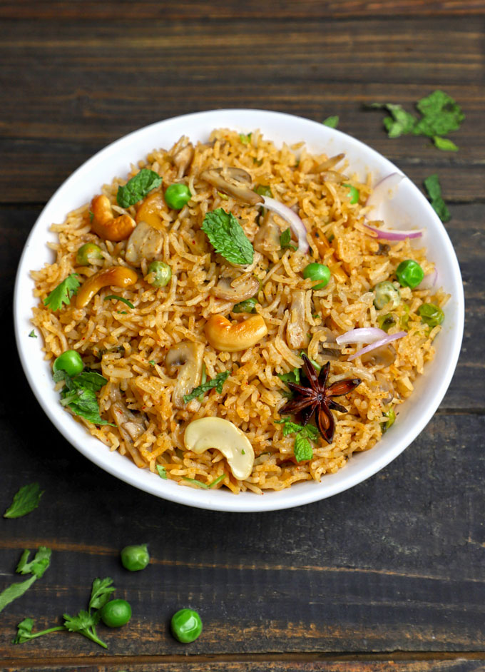 side close up shot of mushroom pulao in a white bowl