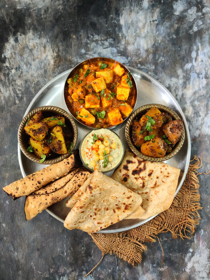 aerial shot of indian thali on a black surface