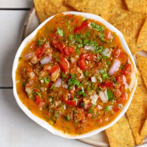 aerial shot of tomato salsa in a white ceramic bowl