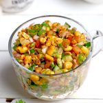 side shot of peanut chaat in a glass mug