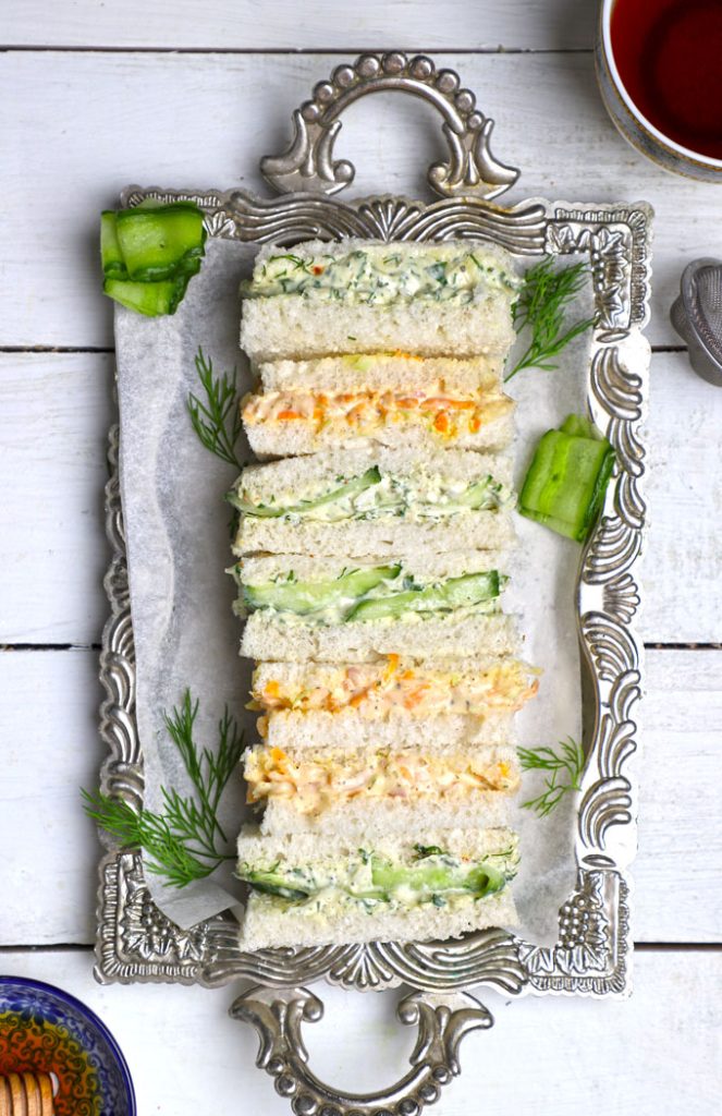 aerial shot of a tea sandwich arranged on a white silver platter