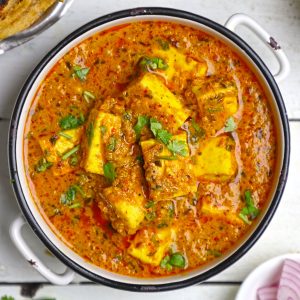 aerial shot of paneer curry in a white ceramic bowl