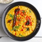 aerial shot of rajasthani kadhi in a black ceramic bowl