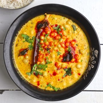 aerial shot of rajasthani kadhi in a black ceramic bowl