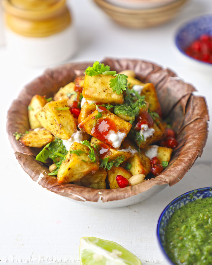 side shot of sweet potato chaat served on a paper plate