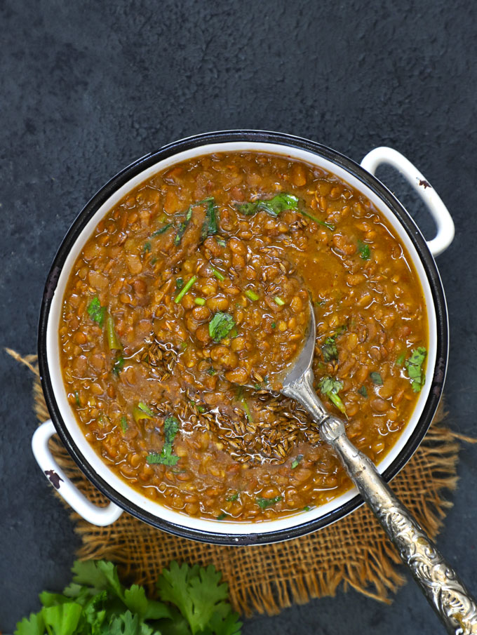 aerial shot of pahadi gahat dal in a white ceramic bowl with the spoon