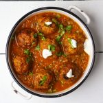 aerial shot of lauki kofta curry in a white ceramic bowl