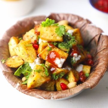 side shot of sweet potato chaat on a paper plate