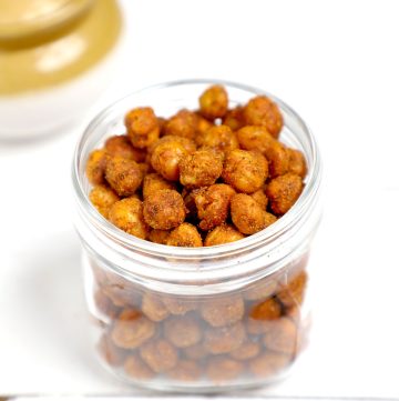 side shot of air fryer crispy chickpeas in a glass jar