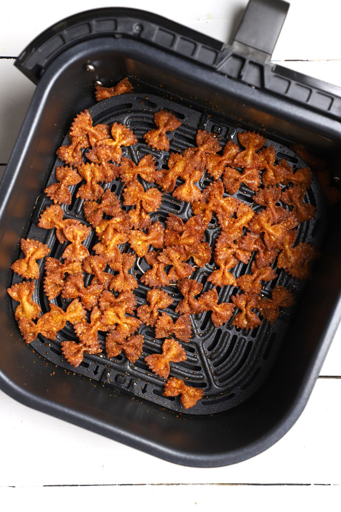 aerial shot of pasta chips in a an air fryer basket