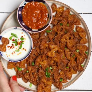 aerial shot of pasta chips stacked on a platter with dips