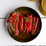 aerial shot of lal mirch ka achar in a stainless steel bowl