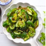 aerial shot of smashed cucumber salad on a white serving platter