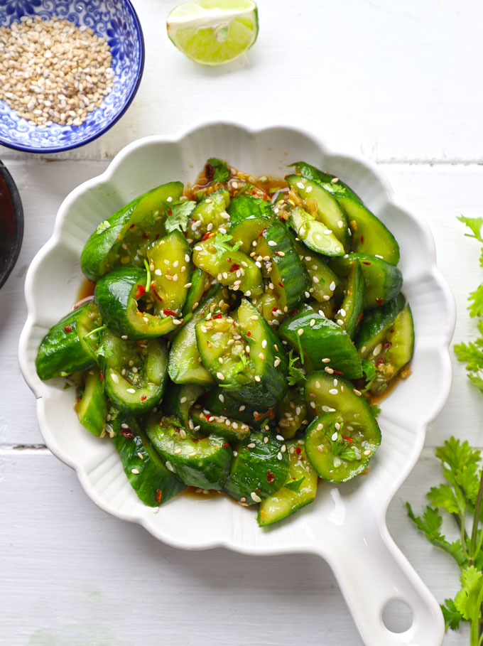 aerial shot of smashed cucumber salad on a white ceramic platter