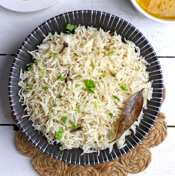 aerial shot of jeera rice in a black ceramic bowl