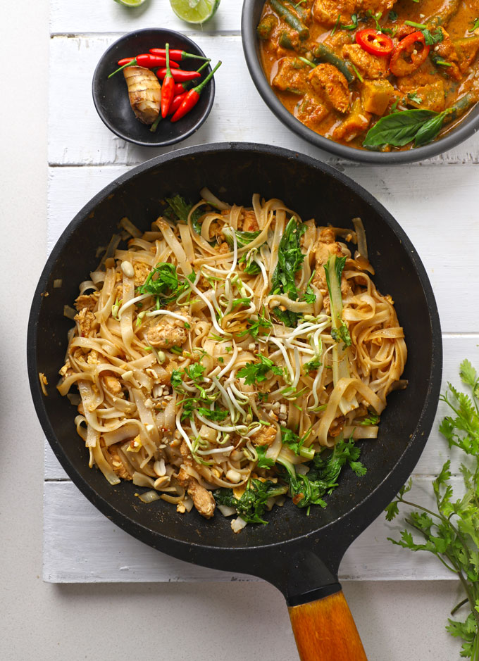 aerial shot of pad thai noodles in a black stir fry pan