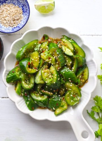 aerial shot of smashed cucumber salad on a white ceramic platter