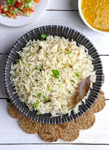 aerial shot of jeera rice in a black ceramic bowl