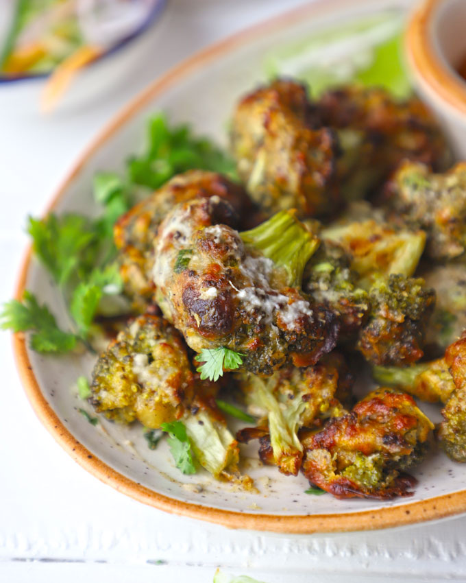 side shot of malai broccoli served on a ceramic platter