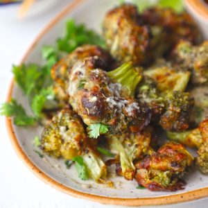 side shot of malai broccoli served on a ceramic platter