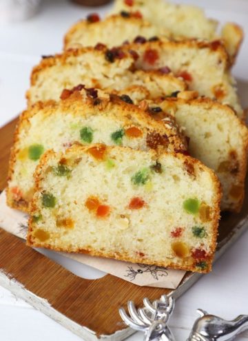 side shot of eggless tutti frutti cake stacked on a platter