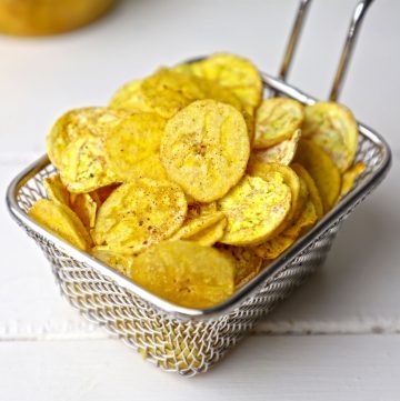 side shot of banana chips stacked on a wire basket