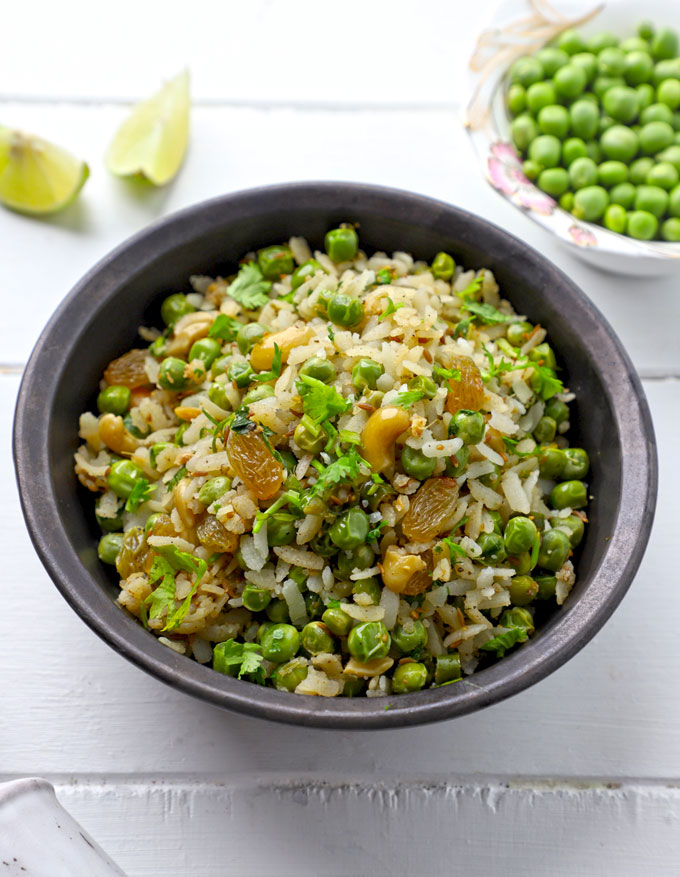 side shot of matar poha served in a black ceramic bowl