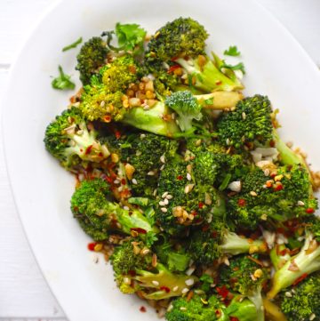 aerial shot of stir fried broccoli served on a white platter