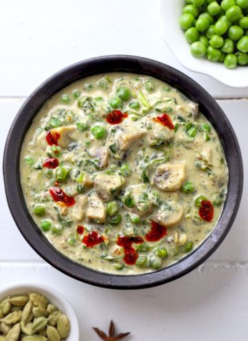 aerial shot of methi matar malai in a black ceramic bowl