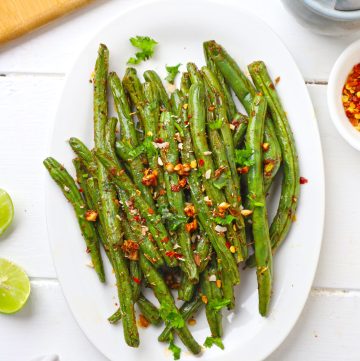 aerial shot of air fryer green beans on a white platter