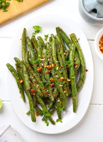 aerial shot of air fryer green beans on a white platter