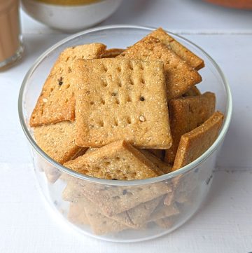 side shot of baked mathri in a glass container