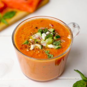 side shot of watermelon gazpacho in a glass mug