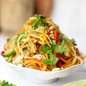 side shot of green papaya salad stacked on a platter