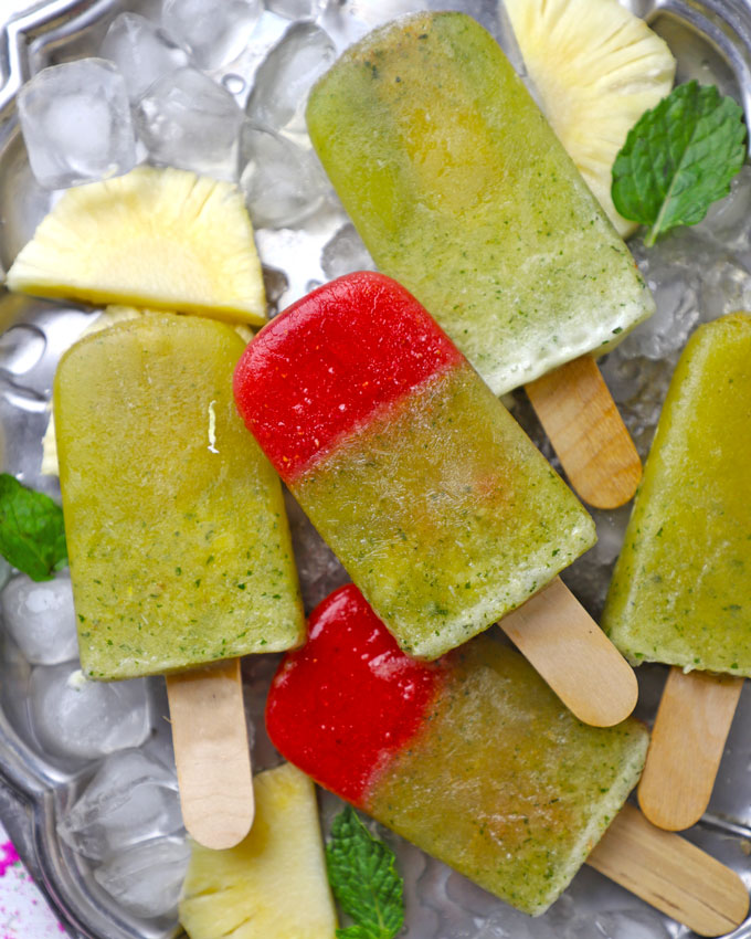 aerial shot of masala pineapple popsicles arranged on a platter with ice cubes