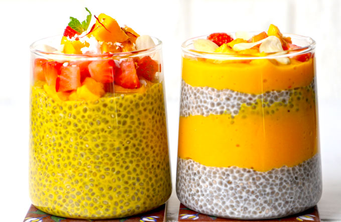 side shot of two glasses of mango chia pudding