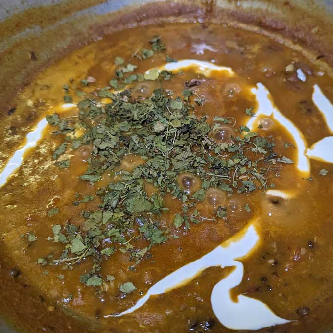 close up shot of makhani dal simmering in a a kadhai