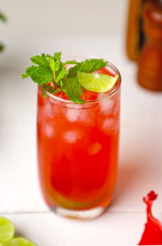 side shot of iced hibiscus tea in a tall glass.