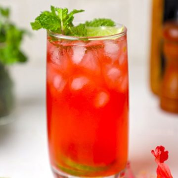 side shot of hibiscus tea served in a tall glass