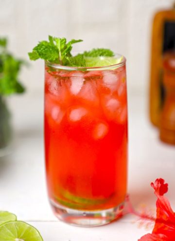 side shot of hibiscus tea served in a tall glass