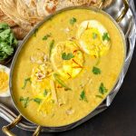 aerial shot of Mughlai Egg Curry served in a traditional Indian platter