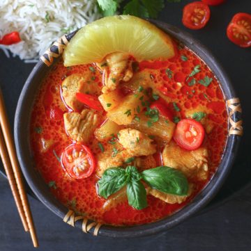aerial shot of pineapple chicken curry in a black stone bowl