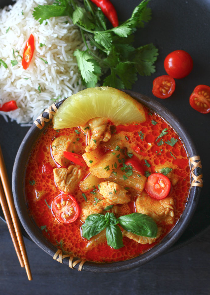 aerial shot of pineapple chicken curry in a black stone bowl