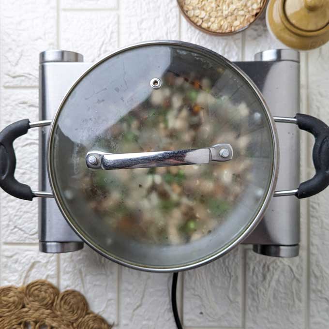 oats soup simmering in a saucepan